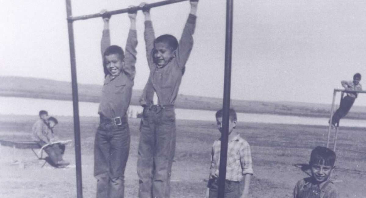 St Joes Students Hanging on Playground Equipment