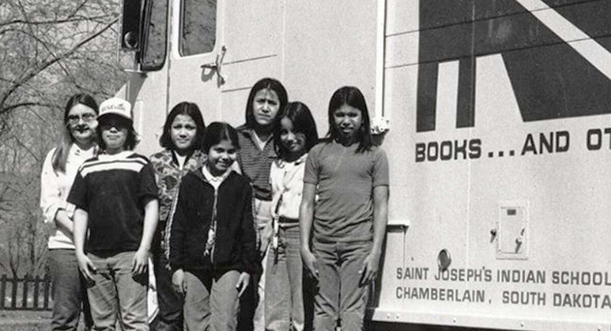 St Joes Students Standing in Front of a Truck