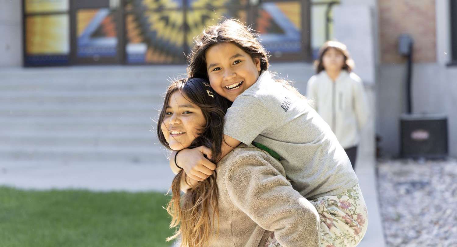 Two girls smiling at the camera