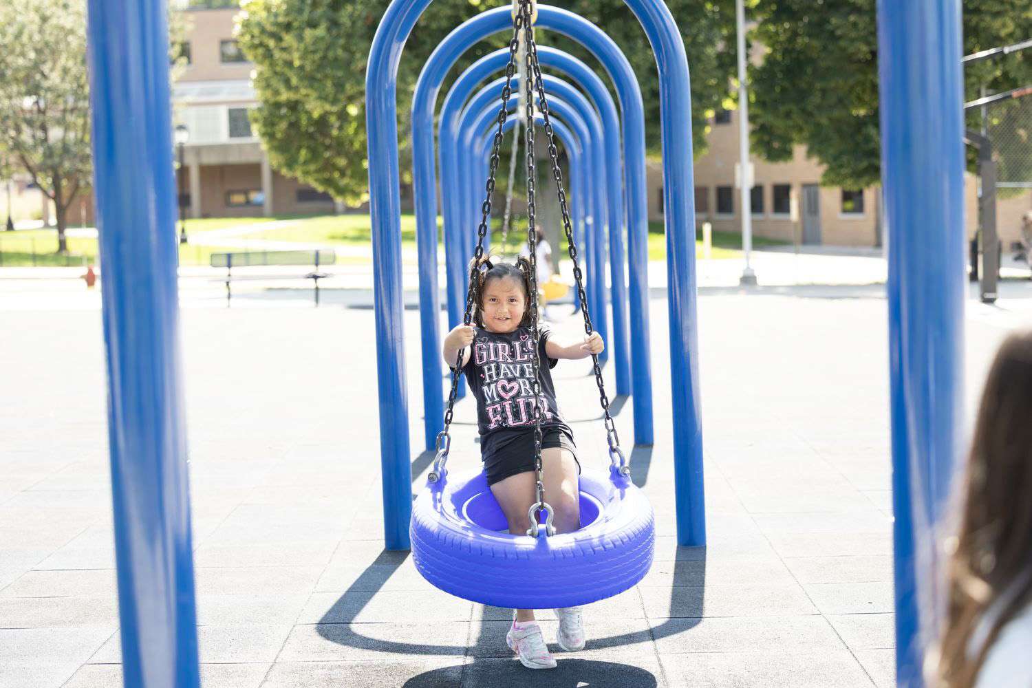 Child playing on a swing set